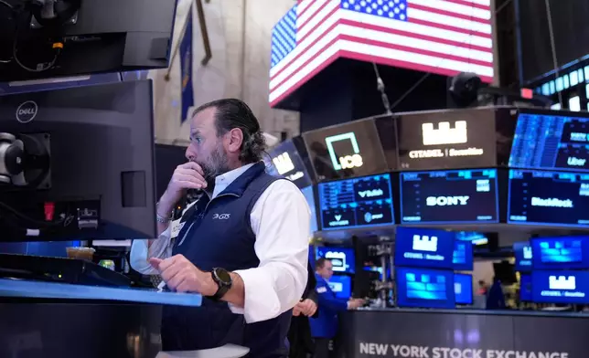 Michael Pistillo works on the floor at the New York Stock Exchange in New York, Tuesday, Nov. 11, 2025. (AP Photo/Seth Wenig)