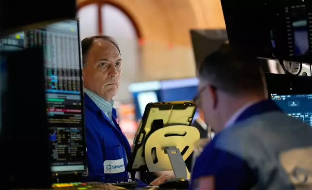 James Conti works on the floor at the New York Stock Exchange in New York, Tuesday, Nov. 11, 2025. (AP Photo/Seth Wenig)
