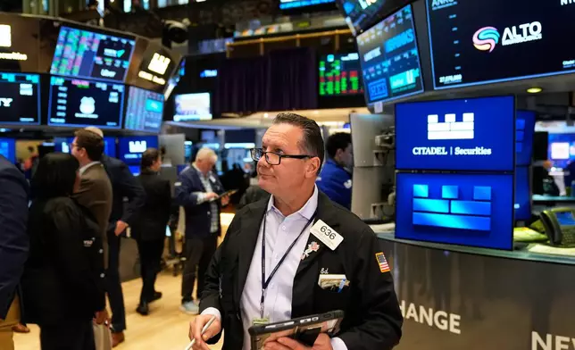 Edward Curran works on the floor at the New York Stock Exchange in New York, Tuesday, Nov. 11, 2025. (AP Photo/Seth Wenig)