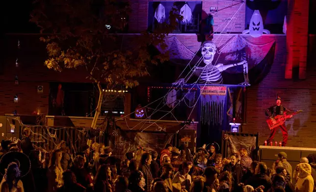 People dressed in scary costumes take part in a Halloween celebration in Paracuellos del Jarama, Spain, Friday, Oct. 31, 2025. (AP Photo/Manu Fernandez)