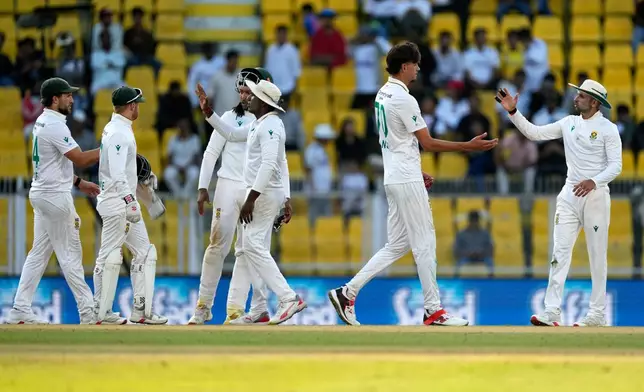 South Africa's Marco Jansen, second right, celebrates with teammates after the dismissal of India's Mohammed Siraj on the third day of the second cricket test match between India and South Africa in Guwahati, India, Saturday, Nov. 22, 2025. (AP Photo/Anupam Nath)