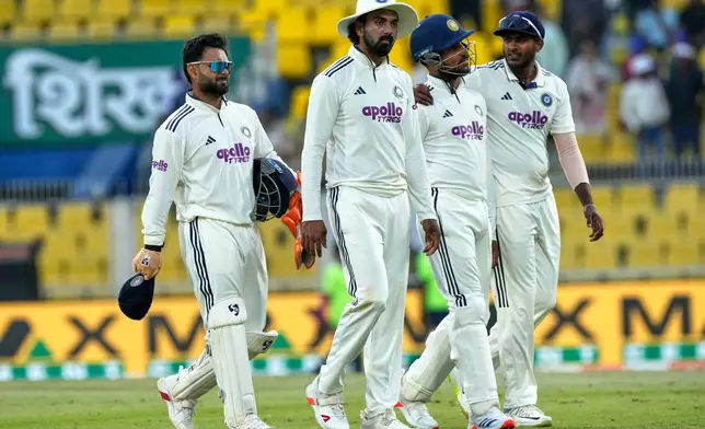 India's players walk off the field at the end of the third day of the second cricket test match between India and South Africa in Guwahati, India, Saturday, Nov. 22, 2025. (AP Photo/Anupam Nath)