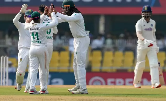 South Africa's players celebrate the dismissal of India's KL Rahul, right, on the third day of the second cricket test match between India and South Africa in Guwahati, India, Saturday, Nov. 22, 2025. (AP Photo/Anupam Nath)