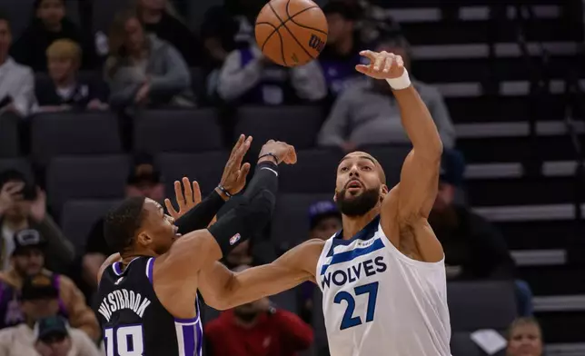 Sacramento Kings guard Russell Westbrook (18) shoots over Minnesota Timberwolves center Rudy Gobert (27) during the first half of an NBA basketball game in Sacramento, Calif., Monday, Nov. 24, 2025. (AP Photo/Randall Benton)