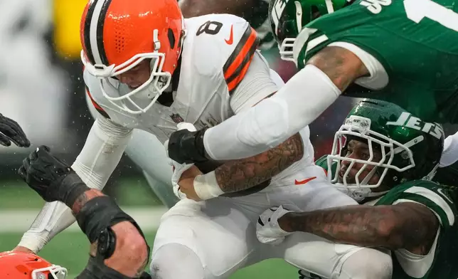 Cleveland Browns quarterback Dillon Gabriel (8) is sacked by New York Jets linebacker Quincy Williams, bottom right, in the second half of an NFL football game Sunday, Nov. 9, 2025, in East Rutherford, N.J. (AP Photo/Yuki Iwamura)