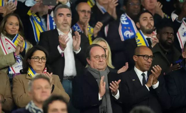 Former French President Francois Hollande applauds from the stands during a World Cup 2026 group D qualifying soccer match between France and Ukraine in Paris, Thursday, Nov. 13, 2025. (AP Photo/Christophe Ena)
