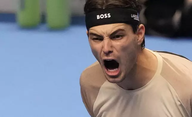 United States' Taylor Fritz celebrates after winning against Italy's Lorenzo Musetti during their singles tennis match of the ATP World Tour Finals, in Turin, Italy, Monday, Nov. 10, 2025. (AP Photo/Antonio Calanni)