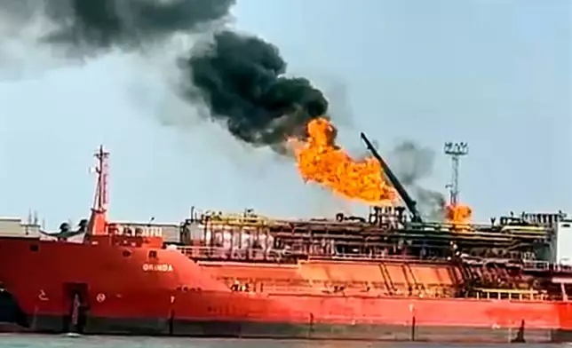This image released on Monday, Nov. 17, 2025 by Romania's Emergency services, ISU, shot from the Romanian side of the border on the Danube river, shows a cargo ship loaded with liquified petroleum gas engulfed by flames following Russian strikes on Ukrainian port infrastructure in Izmail, Ukraine. (ISU Tulcea via AP)