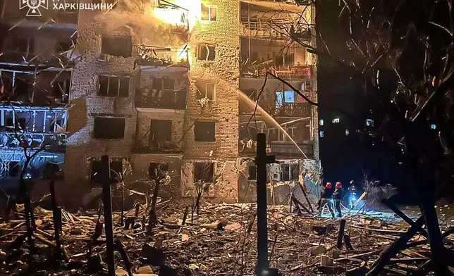 In this photo provided by the Ukrainian Emergency Service, emergency services personnel work to extinguish a fire following a Russian attack in Balakliya, Kharkiv region, Ukraine, Monday, Nov. 17, 2025. (Ukrainian Emergency Service via AP)