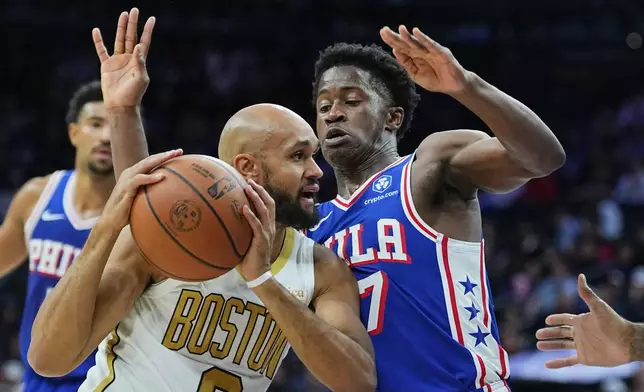 Boston Celtics' Derrick Whiten goes up to shoot against Philadelphia 76ers' Kyle Lowry during the first half of an NBA basketball game Tuesday, Nov. 11, 2025, in Philadelphia. (AP Photo/Matt Rourke)