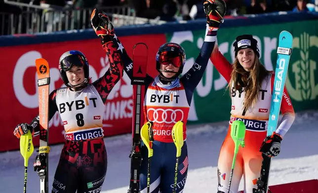 United States' Mikaela Shiffrin, center, winner of an alpine ski, women's World Cup slalom, celebrates with second-placed Albania's Lara Colturi, left, and third-placed Switzerland's Camille Rast, in Gurgl, Austria, Sunday, Nov. 23, 2025. (AP Photo/Pier Marco Tacca)