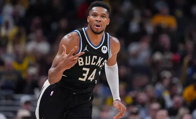 Milwaukee Bucks forward Giannis Antetokounmpo (34) reacts after a three-point basket against the Indiana Pacers during the second half of an NBA basketball game in Indianapolis, Monday, Nov. 3, 2025. (AP Photo/Michael Conroy)