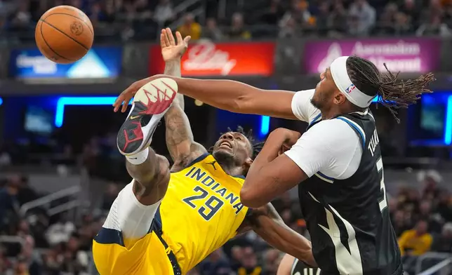 Milwaukee Bucks center/forward Myles Turner (3) fouls Indiana Pacers guard Quenton Jackson (29) as he shoots during the second half of an NBA basketball game in Indianapolis, Monday, Nov. 3, 2025. (AP Photo/Michael Conroy)