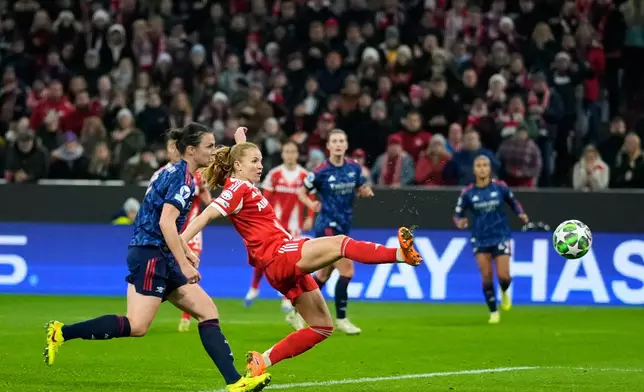 Bayern's Glodis Viggosdottir, center, scores her side's third goal during the women's Champions League opening phase soccer match between FC Bayern Munich and Arsenal FC in Munich, Germany, Wednesday, Nov. 12, 2025. (AP Photo/Matthias Schrader)