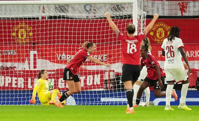Manchester United's Fridolina Rolfo celebrates scoring their side's second goal as Paris Saint-Germain goalkeeper Mary Earps, left, reacts during the women's Champions League opening phase soccer match between Manchester United and Paris Saint-Germain in Manchester, Wednesday, Nov. 12, 2025. (Martin Rickett/PA via AP)