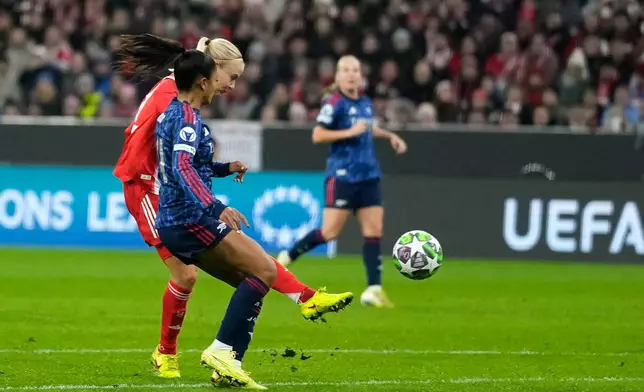 Bayern's Pernille Harder, left, scores her side's second goal during the women's Champions League opening phase soccer match between FC Bayern Munich and Arsenal FC in Munich, Germany, Wednesday, Nov. 12, 2025. (AP Photo/Matthias Schrader)