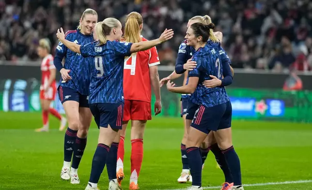 Arsenal's Emily Fox, right, celebrates after scoring the opening goal during the women's Champions League opening phase soccer match between FC Bayern Munich and Arsenal FC in Munich, Germany, Wednesday, Nov. 12, 2025. (AP Photo/Matthias Schrader)
