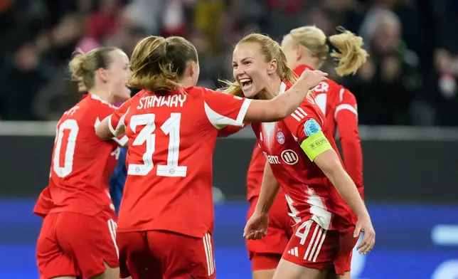 Bayern's Glodis Viggosdottir, right, celebrates after scoring her side's third goal during the women's Champions League opening phase soccer match between FC Bayern Munich and Arsenal FC in Munich, Germany, Wednesday, Nov. 12, 2025. (AP Photo/Matthias Schrader)