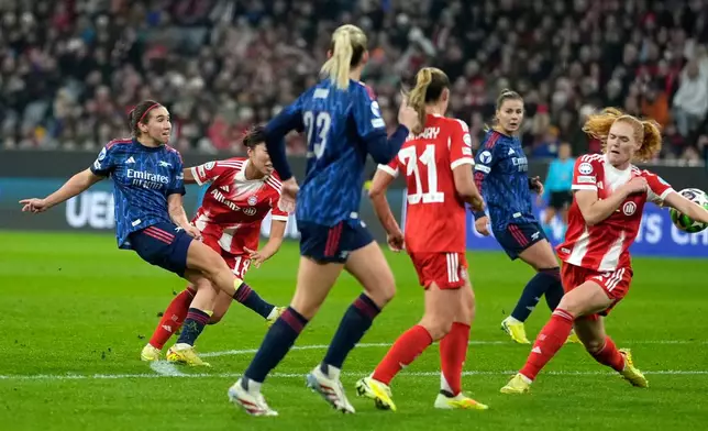 Arsenal's Mariona Caldentey, left, scores her side's second goal during the women's Champions League opening phase soccer match between FC Bayern Munich and Arsenal FC in Munich, Germany, Wednesday, Nov. 12, 2025. (AP Photo/Matthias Schrader)