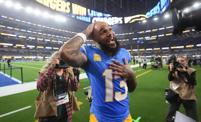 Los Angeles Chargers wide receiver Keenan Allen (13) celebrates after becoming the team's all-time leader in receptions after an NFL football game against the Pittsburgh Steelers, Sunday, Nov. 9, 2025, in Inglewood, Calif. (AP Photo/Marcio Jose Sanchez)