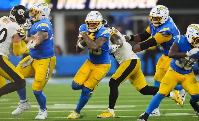 Los Angeles Chargers wide receiver Keenan Allen (13) carries the ball after making a catch during the second half of an NFL football game against the Pittsburgh Steelers Sunday, Nov. 9, 2025, in Inglewood, Calif. (AP Photo/Marcio Jose Sanchez)