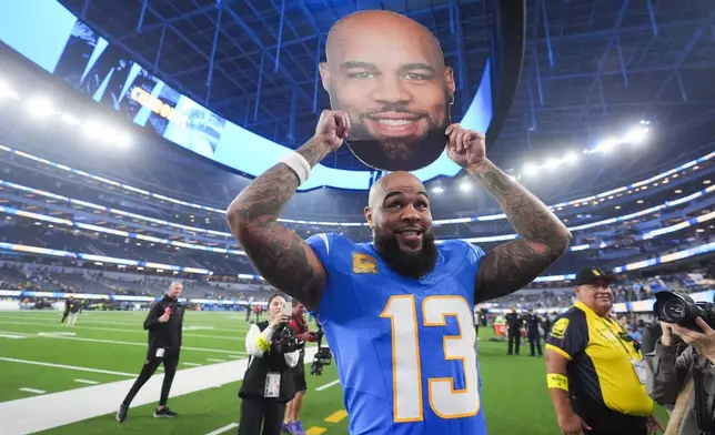 Los Angeles Chargers wide receiver Keenan Allen (13) celebrates after becoming the team's all-time leader in receptions in an NFL football game against the Pittsburgh Steelers, Sunday, Nov. 9, 2025, in Inglewood, Calif. (AP Photo/Marcio Jose Sanchez)