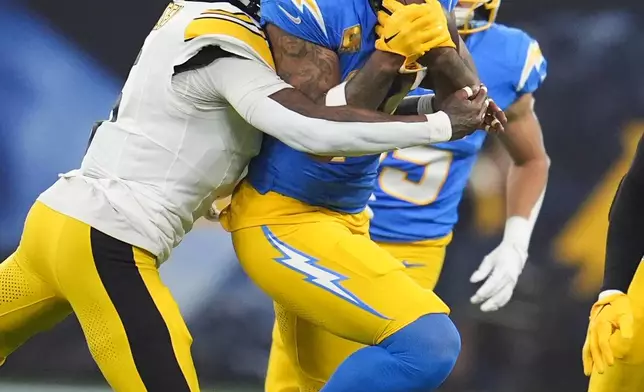 Los Angeles Chargers wide receiver Keenan Allen (13) makes a catch against Pittsburgh Steelers cornerback Jalen Ramsey (5) during the second half of an NFL football game Sunday, Nov. 9, 2025, in Inglewood, Calif. (AP Photo/Marcio Jose Sanchez)