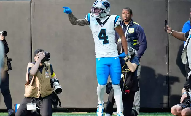 Carolina Panthers wide receiver Tetairoa McMillan (4) celebrates his touchdown reception in the second half of an NFL football game against the Atlanta Falcons, Sunday, Nov. 16, 2025, in Atlanta. (AP Photo/Mike Stewart)
