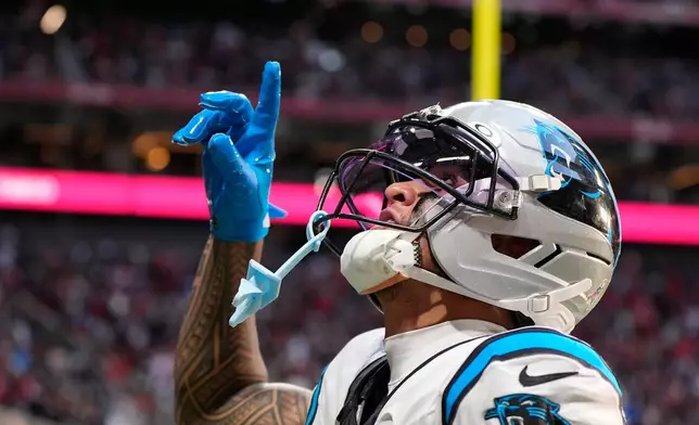 Carolina Panthers wide receiver Tetairoa McMillan (4) celebrates his touchdown reception in the second half of an NFL football game against the Atlanta Falcons, Sunday, Nov. 16, 2025, in Atlanta. (AP Photo/Brynn Anderson)