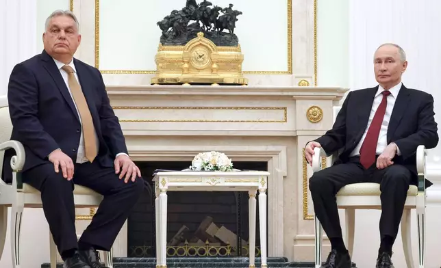 Russian President Vladimir Putin, right, attends a meeting with Hungarian Prime Minister Viktor Orban at the Senate Palace of the Kremlin in Moscow, Russia, Friday, Nov. 28, 2025. (Vladimir Gerdo, Sputnik, Kremlin Pool Photo via AP)
