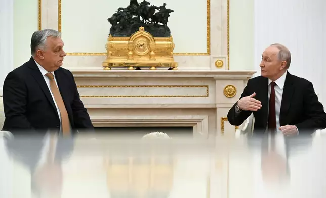 Russian President Vladimir Putin, right, speaks with Hungarian Prime Minister Viktor Orban during their meeting at the Senate Palace of the Kremlin in Moscow, Russia, Friday, Nov. 28, 2025. (Alexander Nemenov/Pool Photo via AP)