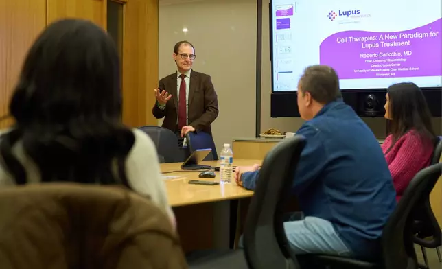 Dr. Roberto Caricchio, center, director of the Lupus Center at UMass Chan Medical School, speaks to a lupus support group, Feb. 12, 2025, in Worcester, Mass. (AP Photo/David Goldman)