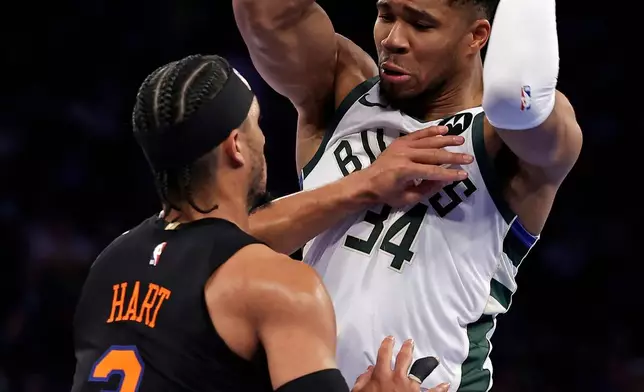 Milwaukee Bucks forward Giannis Antetokounmpo looks to pass while being defended by New York Knicks guard Josh Hart (3) during the first half of an NBA Cup basketball game Friday, Nov. 28, 2025, in New York. (AP Photo/Adam Hunger)