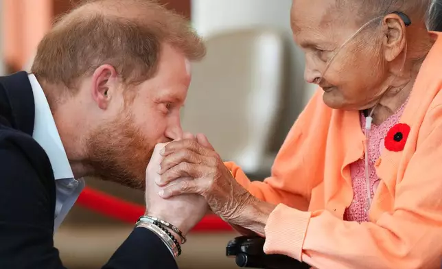 Prince Harry meets Villa Shah, 91, as he meets with some of Canada's oldest veterans, joining them in a creative arts program at Sunnybrook Hospital's veterans center in Toronto, Thursday, Nov. 6, 2025. (Nathan Denette /The Canadian Press via AP)