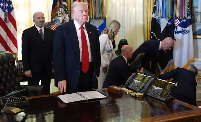 Commerce Secretary Howard Lutnick, from left, President Donald Trump, Heidi Overton, White House domestic policy council, David Moore, president of Novo Nordisk Inc., Novo Nordisk President and CEO Mike Doustdar and Mehmet Oz, administrator of the Centers for Medicare &amp; Medicaid Services, look on after a person collapsed during an event about drug prices, Thursday, Nov. 6, 2025, in the Oval Office of the White House in Washington. (AP Photo/Evan Vucci)