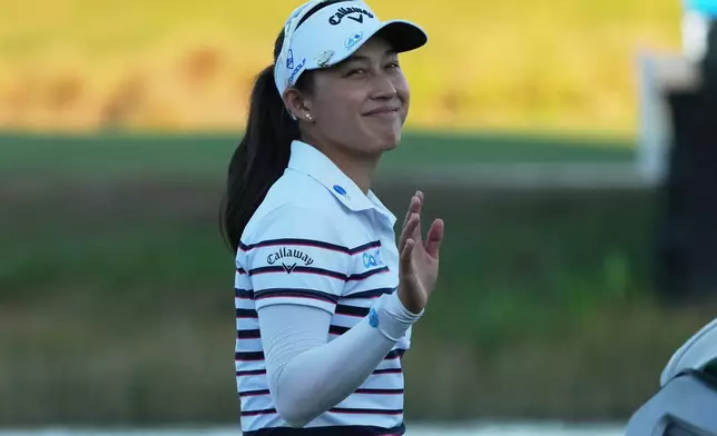 Jeeno Thitikul of Thailand waves as she approaches the 18th green during the third round of the LPGA Tour Championship golf tournament, Saturday, Nov. 22, 2025, in Naples, Fla. (AP Photo/Marta Lavandier)