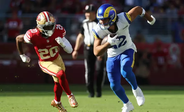 Los Angeles Rams wide receiver Puka Nacua, right, runs against San Francisco 49ers cornerback Upton Stout (20) during the first half of an NFL football game in Santa Clara, Calif., Sunday, Nov. 9, 2025. (AP Photo/Jed Jacobsohn)