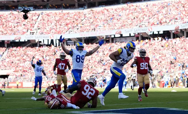 Los Angeles Rams wide receiver Puka Nacua (12) scores against the San Francisco 49ers during the first half of an NFL football game in Santa Clara, Calif., Sunday, Nov. 9, 2025. (AP Photo/Godofredo A. Vásquez)