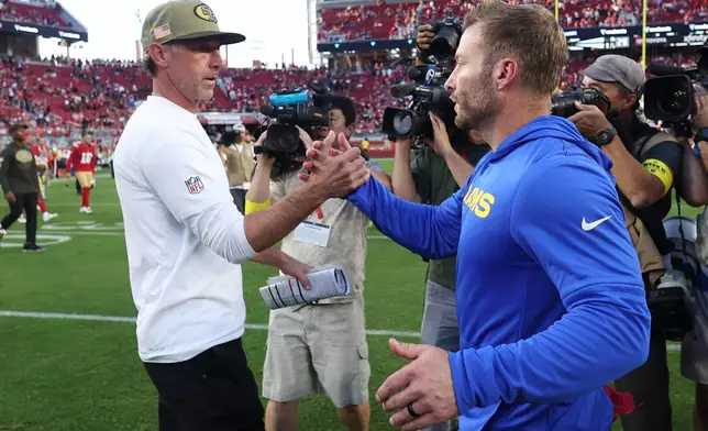 San Francisco 49ers head coach Kyle Shanahan, left, shakes hands with Los Angeles Rams head coach Sean McVay after an NFL football game in Santa Clara, Calif., Sunday, Nov. 9, 2025. (AP Photo/Jed Jacobsohn)