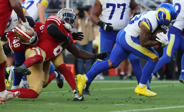 Los Angeles Rams running back Kyren Williams, right, runs toward the end zone to score past San Francisco 49ers safety Malik Mustapha (6) and linebacker Tatum Bethune (48) during the second half of an NFL football game in Santa Clara, Calif., Sunday, Nov. 9, 2025. (AP Photo/Jed Jacobsohn)