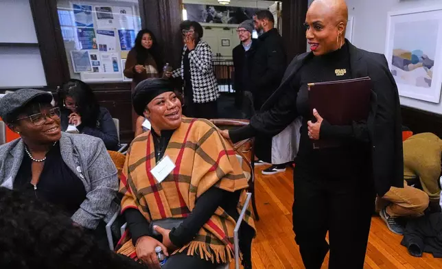 U.S. Rep. Ayanna Pressley, D-Mass., right, greets guests while arriving for a roundtable meeting, Monday, Nov. 24, 2025, in Boston. (AP Photo/Charles Krupa)