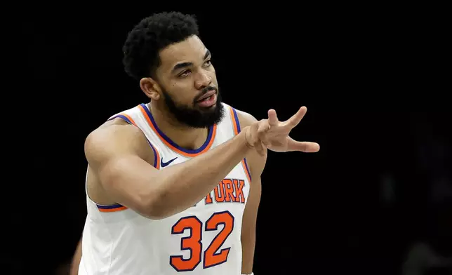 New York Knicks center Karl-Anthony Towns reacts after making a three-point basket during the second half of an NBA basketball game against the Brooklyn Nets, Monday, Nov. 24, 2025, in New York. (AP Photo/Adam Hunger)