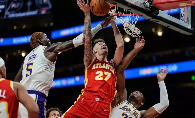 Atlanta Hawks guard Vit Krejci (27) shoots against Los Angeles Lakers forward Rui Hachimura (28) during the first half of an NBA basketball game, Saturday, Nov. 8, 2025, in Atlanta. (AP Photo/Mike Stewart)