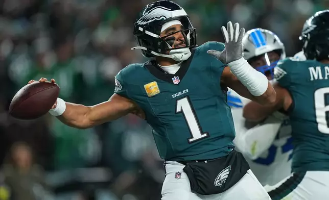 Philadelphia Eagles quarterback Jalen Hurts (1) looks to pass during the second half of an NFL football game against the Detroit Lions on Sunday, Nov. 16, 2025, in Philadelphia. (AP Photo/Matt Rourke)