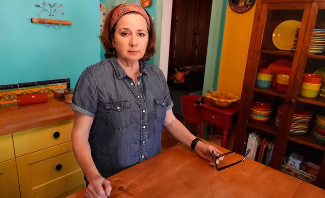 Gigi Cervantes, who resigned from her position as a theater teacher at a Fort Worth school rather than teach in a classroom where the Ten Commandments are hung, poses for a photo at her home, Wednesday, Nov. 5, 2025, in Fort Worth, Texas. (AP Photo/Tony Gutierrez)
