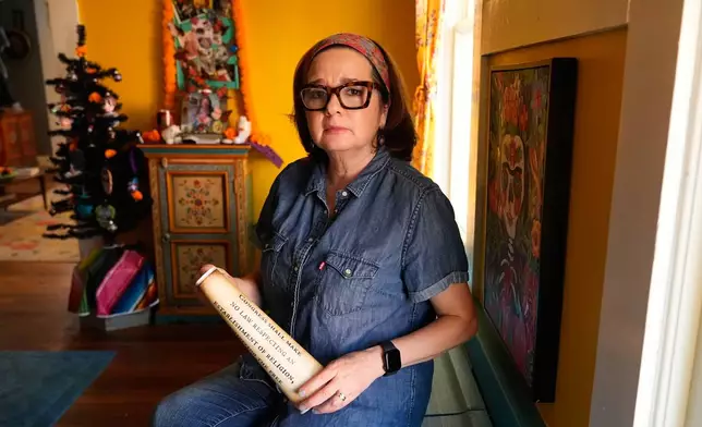 Gigi Cervantes, who resigned from her position as a theater teacher at a Fort Worth school rather than teach in a classroom where the Ten Commandments are hung, poses for a photo at her home, Wednesday, Nov. 5, 2025, in Fort Worth, Texas. (AP Photo/Tony Gutierrez)