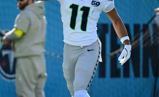 Seattle Seahawks wide receiver Jaxon Smith-Njigba celebrates after scoring a touchdown against the Tennessee Titans during the first half of an NFL football game Sunday, Nov. 23, 2025, in Nashville, Tenn. (AP Photo/John Amis)