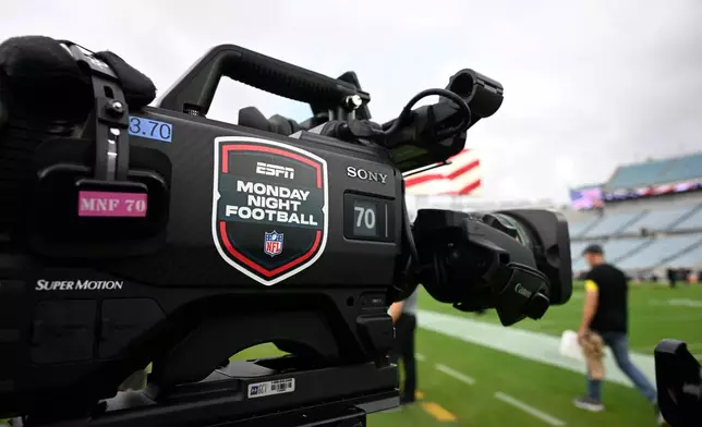 FILE - An ESPN Monday Night Football logo is viewed on a broadcast camera before an NFL football game between the Jacksonville Jaguars and the Kansas City Chiefs, Monday, Oct. 6, 2025, in Jacksonville, Fla. (AP Photo/Phelan M. Ebenhack, File)
