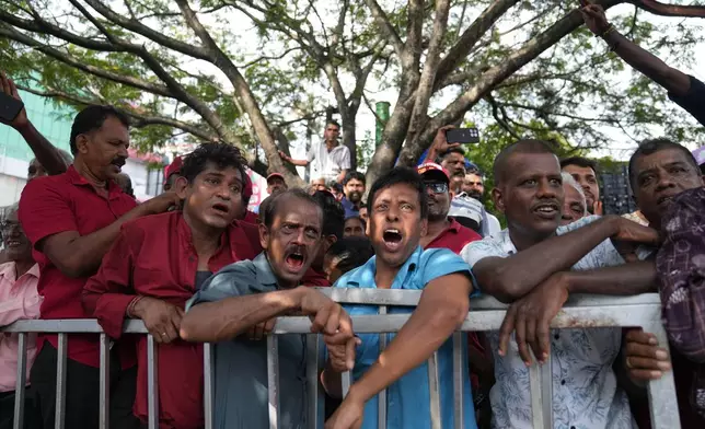 People shout anti government slogans supporting Sri Lankan lawmaker Namal Rajapaksa, heir to the once-powerful Rajapaksa dynasty, during a public rally in Colombo, Sri Lanka, Friday, Nov. 21, 2025. (AP Photo/Eranga Jayawardena)