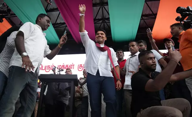 Sri Lankan lawmaker Namal Rajapaksa, heir to the once-powerful Rajapaksa dynasty, waves to supporters during a public rally in Colombo, Sri Lanka, Friday, Nov. 21, 2025. (AP Photo/Eranga Jayawardena)